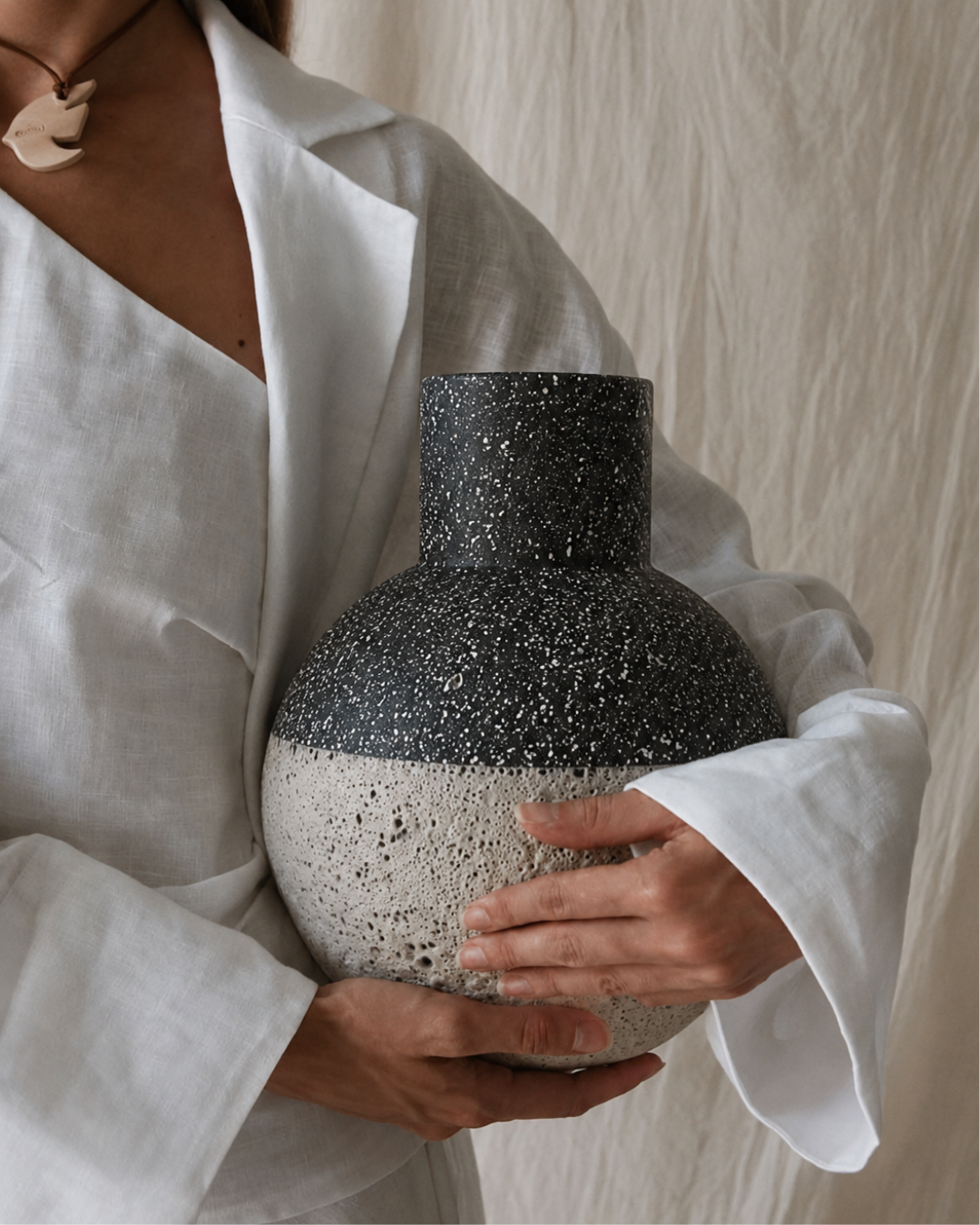 Speckled terrazzo vase, held